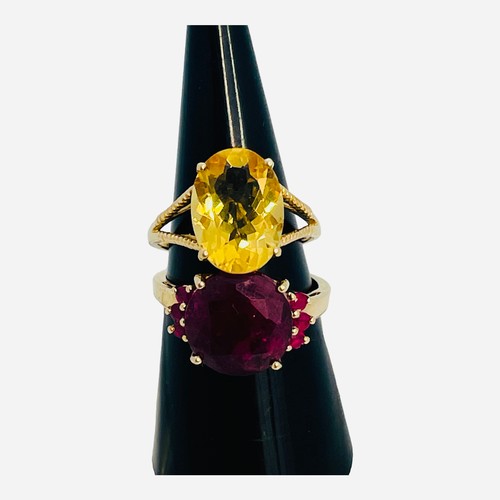 188 - A 9ct yellow gold dress ring, set with a round faceted garnet, with 3 x small garnets set to each sh... 