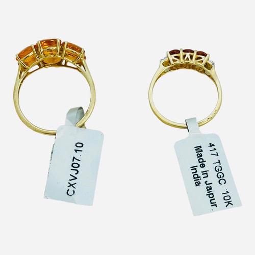 191 - Two 9ct yellow gold dress rings, both claw set with orange coloured faceted stones, total weight 6.5... 