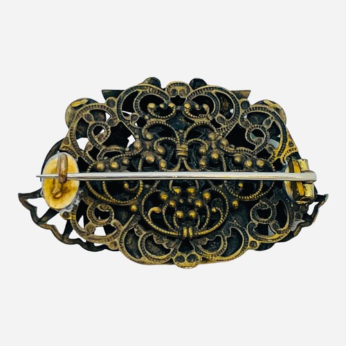 197 - A gilt metal brooch influenced by Egyptian Revival, probably Max Neiger of Gablonz, set with simulat... 