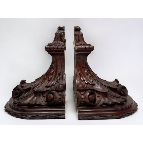 290 - A pair of mahogany wall brackets, by John Taylor of Edinburgh, carved as classical composite capital... 