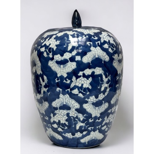 11 - A large Chinese blue ground porcelain ovoid jar and cover, decorated with butterflies, 30cm high, to... 