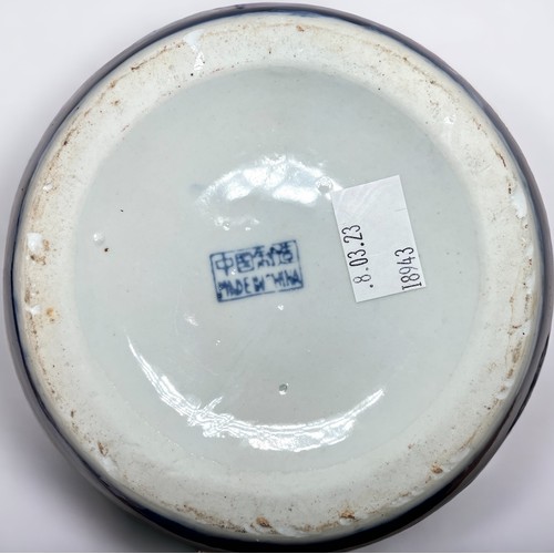 11 - A large Chinese blue ground porcelain ovoid jar and cover, decorated with butterflies, 30cm high, to... 