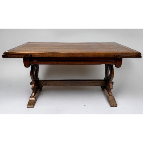 531 - A Bevan Funnell Ltd 'Reprodux' oak draw-leaf extending trestle dining table with pierced shaped tres... 