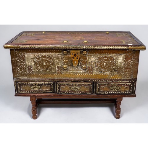 535 - An antique Zanzibar hardwood and brass studded coffer/mule chest, the brass studded hinged top enclo... 