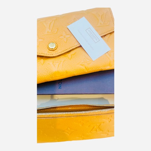 275A - A Louis Vuitton Sarah Monogram Empreinte leather portfolio wallet, saffron yellow colour, gold hardw... 