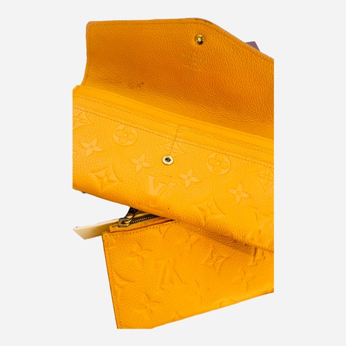 275A - A Louis Vuitton Sarah Monogram Empreinte leather portfolio wallet, saffron yellow colour, gold hardw... 