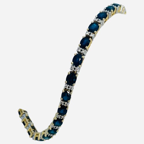 201 - A 14ct yellow gold line-bracelet, claw set with oval faceted sapphires, and small round diamonds, to... 