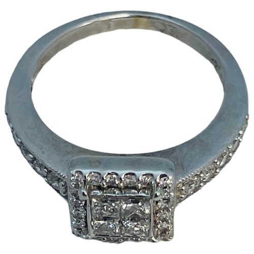 203 - An 18ct white gold diamond ring, set with 4 x princess cut diamonds to the centre, with small round ... 