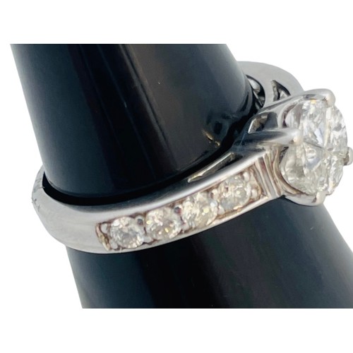 209 - An 18ct white gold diamond ring, set with 4 x triangular cut diamonds to the centre, in an invisible... 