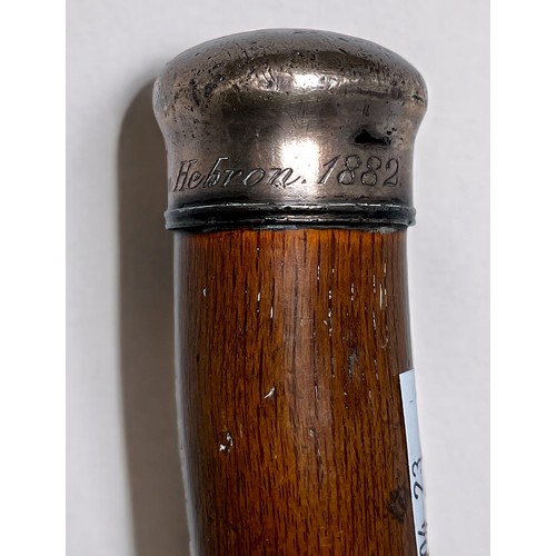 299 - A Victorian Oak Walking Cane, the white-metal top engraved ‘Oak From Hebron 1882,’ top with monogram... 