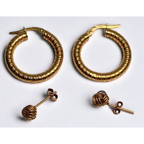 219 - A pair of 9ct gold hoops earrings, gross weight approximately 1.3g and a pair of yellow metal stud e... 