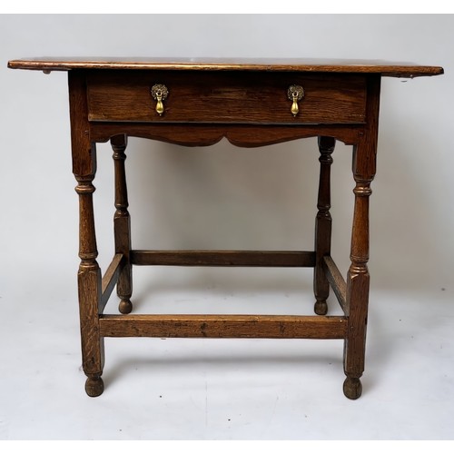 543 - An 18th century oak side table of rectangular form, with single frienze drawer and brass drop handle... 