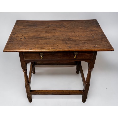 543 - An 18th century oak side table of rectangular form, with single frienze drawer and brass drop handle... 