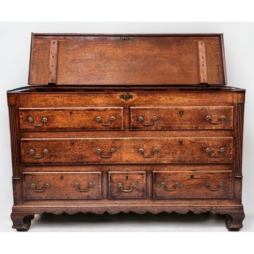 537 - An 18th century oak Mule Chest, the hinged top enclosing a shallow compartment, the front with a pai... 