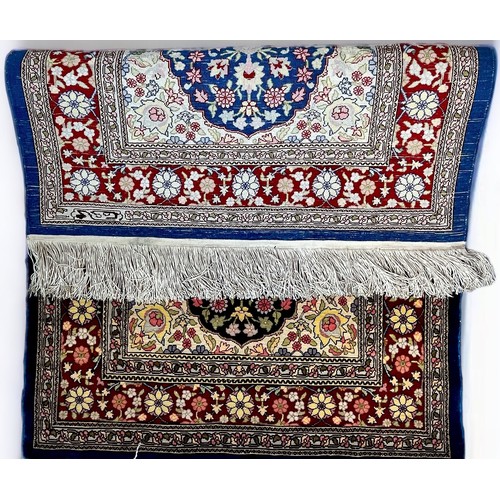 407 - A hand-knotted Persian silk rug, finely work in multi-coloured silk with central floral  blue ground... 