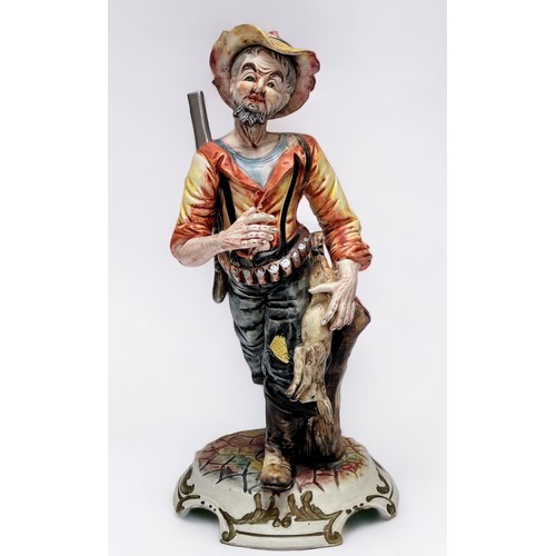 37 - A Capodimonte figure of a huntsman with rabbit walking by a tree stump, with factory marks to base, ... 