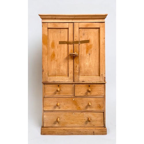 547 - A pine linen press, the shaped cornice above two cupboard doors enclosing shelves, over two short an... 