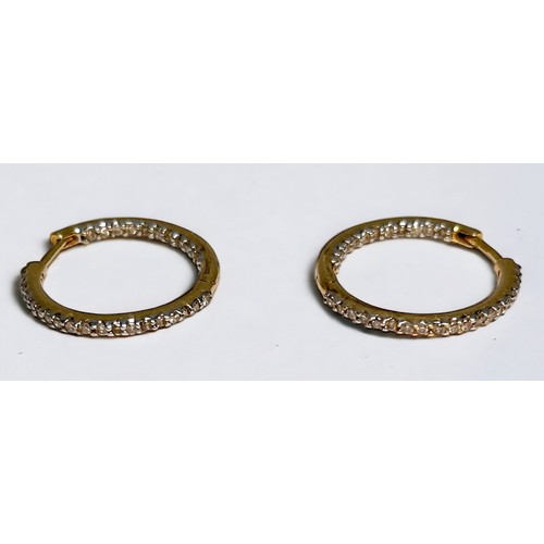 240 - A pair of 18ct gold hoop earrings, set to the outside and opposing inside edge with small diamonds, ... 