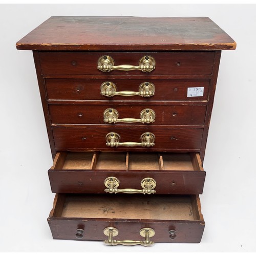 315 - A stained wooden specimen cabinet, with six drawers, each with brass pulls enclosing compartmented i... 