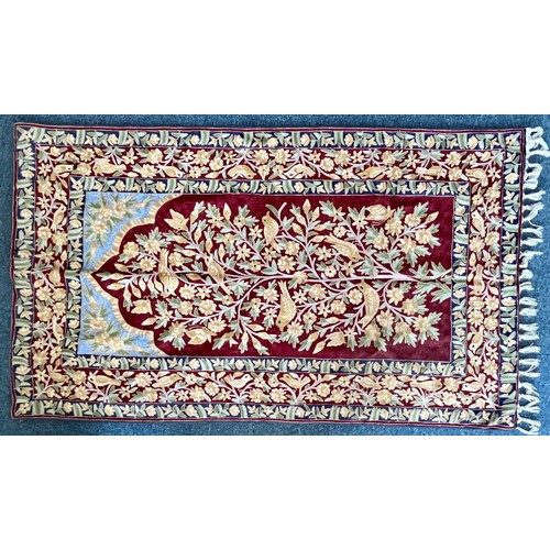 410 - A handmade Crewel work fringed prayer rug, worked with birds and tree of life, 150x88cm