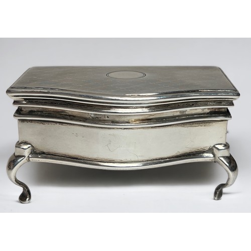 85 - An early 20th century silver casket with serpentine front, engine-turned decoration to the cover, gr... 