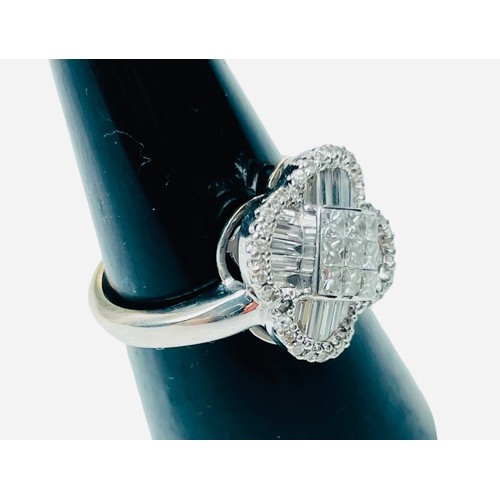 244 - An 18ct white gold dress ring, set with 9 x princess cut diamonds to the centre, in an invisible set... 