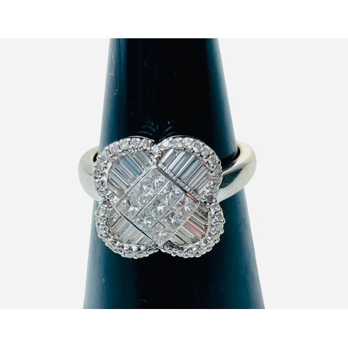 244 - An 18ct white gold dress ring, set with 9 x princess cut diamonds to the centre, in an invisible set... 