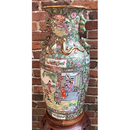 62 - A pair of large 20th century famille rose baluster vases, each decorated in Canton enamels with pane... 