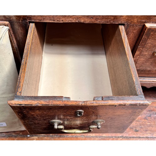 537 - An 18th century oak Mule Chest, the hinged top enclosing a shallow compartment, the front with a pai... 