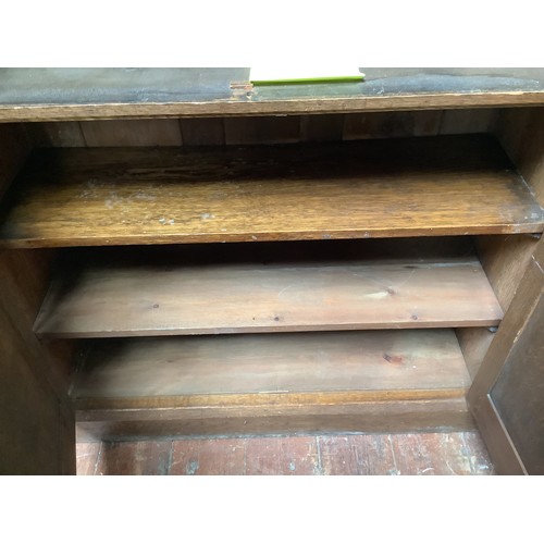 536 - An early 20th century oak bookcase in in Arts and Crafts style, the frieze with applied black letter... 