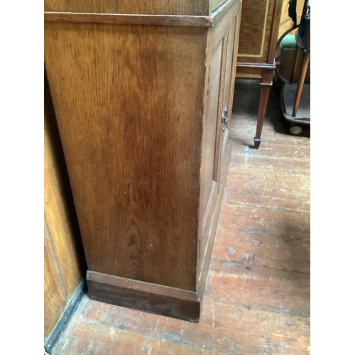 536 - An early 20th century oak bookcase in in Arts and Crafts style, the frieze with applied black letter... 