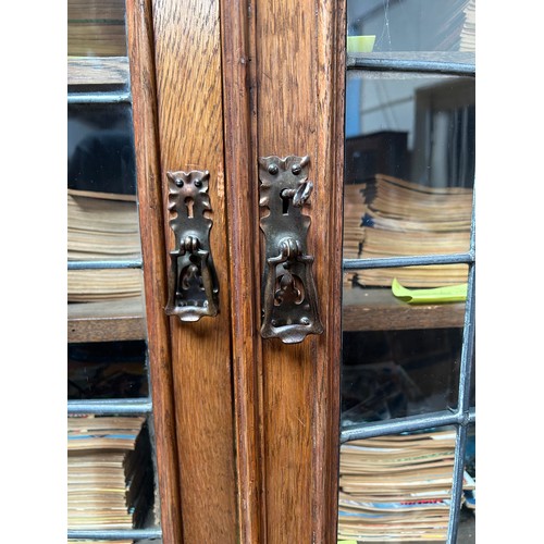 536 - An early 20th century oak bookcase in in Arts and Crafts style, the frieze with applied black letter... 