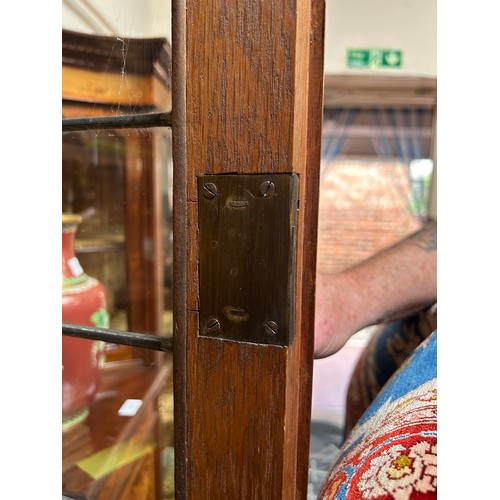 536 - An early 20th century oak bookcase in in Arts and Crafts style, the frieze with applied black letter... 