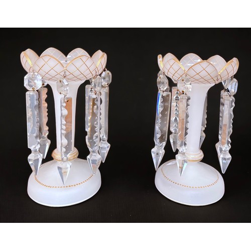 13 - A pair of white frosted glass lustres with gilded decoration, crenellated circular tops raised on cy... 