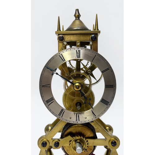 399 - A brass skeleton clock, the silvered chapter ring with Roman numerals denoting hours, with fusee mov... 