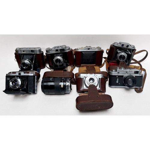 390 - Seven assorted cameras and a lens, including, Seagull 203, no. 67950, in fitted leather case with me... 