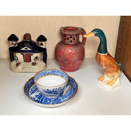 39 - A Barnstaple pottery puzzle jug with incised rouge glaze, together with a Beswick standing duck with... 