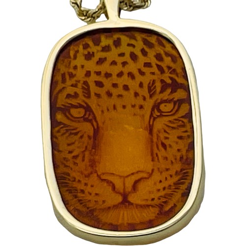 184 - A 14ct yellow gold cushion cut amber pendant, with sharp Cheetah icon, on a 14ct yellow gold rope ch... 