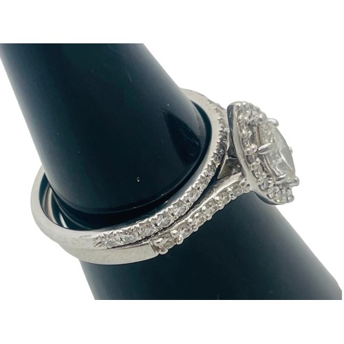 209 - A platinum and diamond halo ring, set with a marquise cut diamond to the centre, surrounded by 20 x ... 