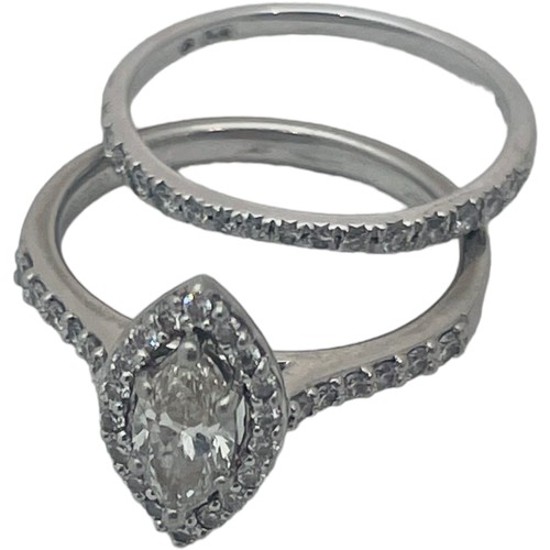 209 - A platinum and diamond halo ring, set with a marquise cut diamond to the centre, surrounded by 20 x ... 