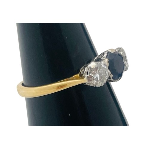 244 - An 18ct yellow gold sapphire and diamond ring, set with a round sapphire to the centre, flanked by t... 