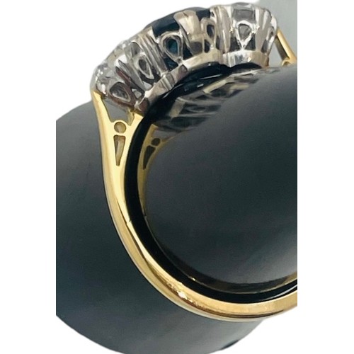 244 - An 18ct yellow gold sapphire and diamond ring, set with a round sapphire to the centre, flanked by t... 