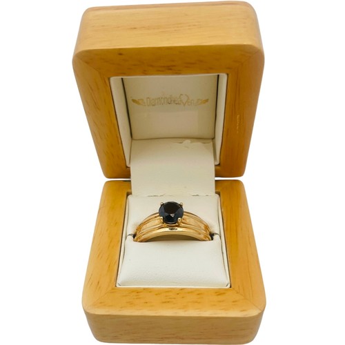 250 - An 18ct yellow gold dress ring, set with a round faceted stone, ring weighs 8.6 grams.