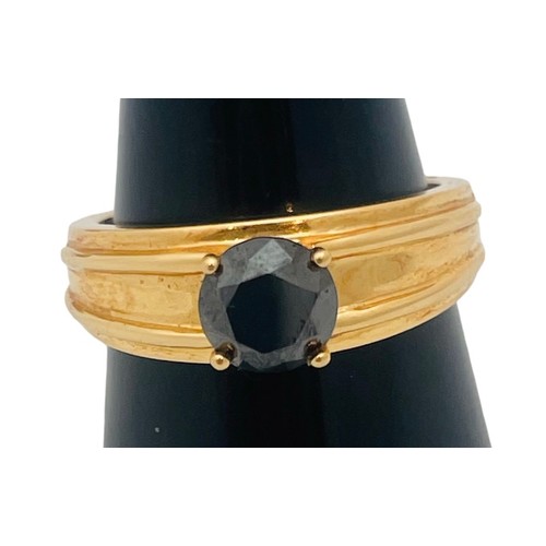 250 - An 18ct yellow gold dress ring, set with a round faceted stone, ring weighs 8.6 grams.