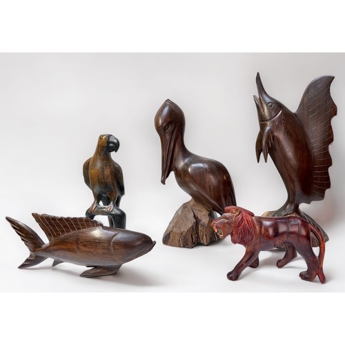 317 - Five various Indonesian carved hardwood figures comprising birds, fish and a lion, largest measures ... 