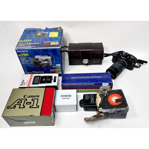 393 - A collection of assorted cameras and accessories comprising a Canon A-1, with a Tamron 28-135mm lens... 