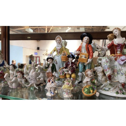 70 - A collection of sixteen German porcelain figures comprising Dresden and Sitzendorf, to include a Sit... 