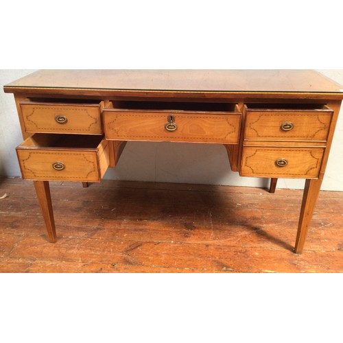 546 - An Edwardian inlaid walnut desk, the frieze with three drawers, above two further drawers, raised on... 