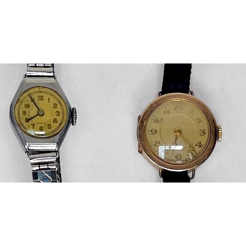 143 - A ladies 9ct gold cased wristwatch, the gilt dial with Arabic numerals denoting hours, on black fabr... 