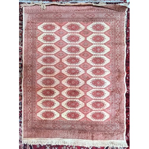 420 - A Caucasian style rug, worked with stylised guls, orange on cream ground, 135cm x 195cm